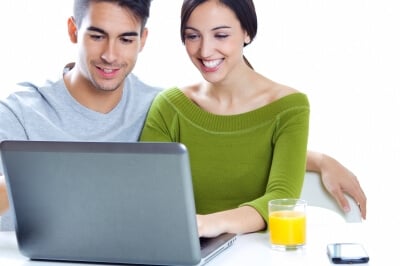 Young Couple searching for homes on web